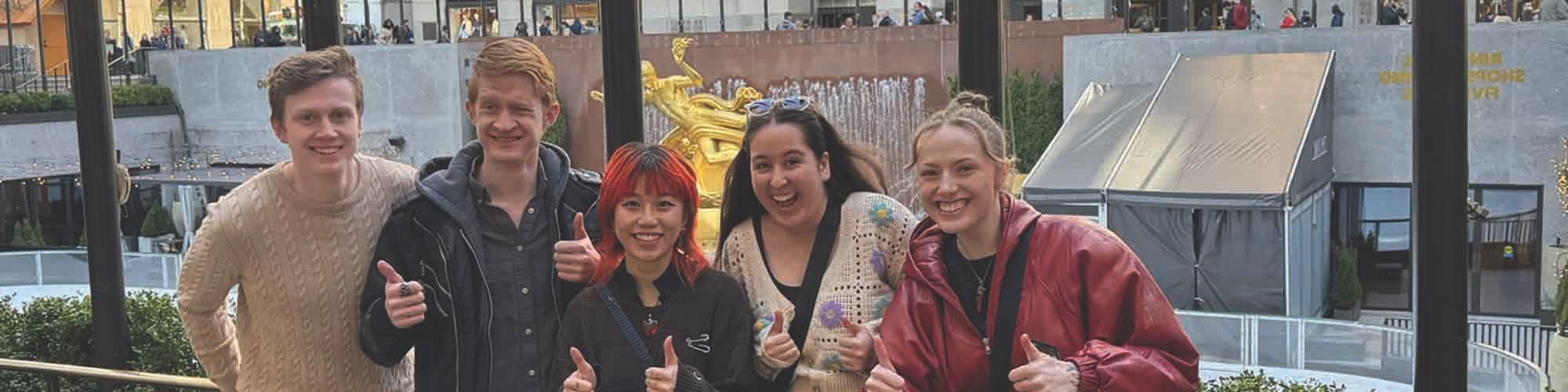 Students smiling in Rockefeller Plaza.